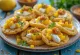 Sev puri mangopaloilla, jogurtilla ja mausteilla tarjoiltuna